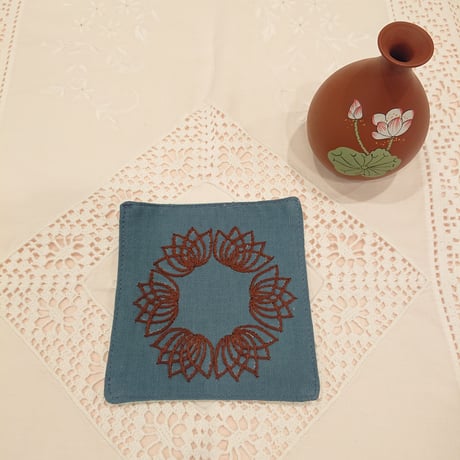 Set of 2 Vietnamese hand-embroidered coasters in a lotus motif, blue and brown