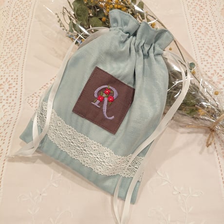 Hand-embroidered initial R drawstring bag